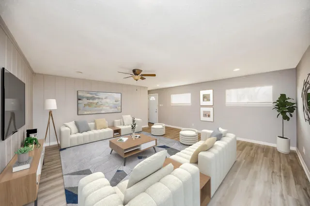 a living room with furniture and a large window