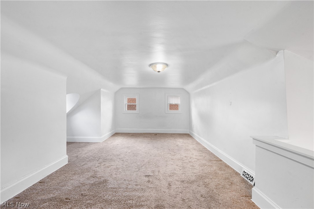 371 Merriman Road Akron, OH 44303 - Photo 25 of 27 Expansive carpeted room with multiple windows, a ceiling-mounted light fixture, white painted walls, and white baseboards