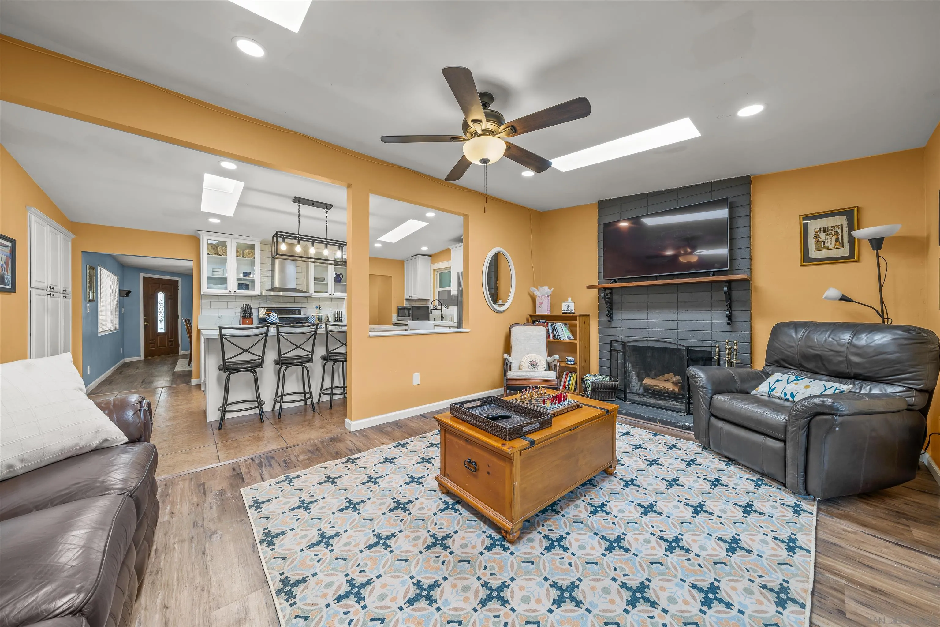 a living room with furniture a dining table and a fireplace