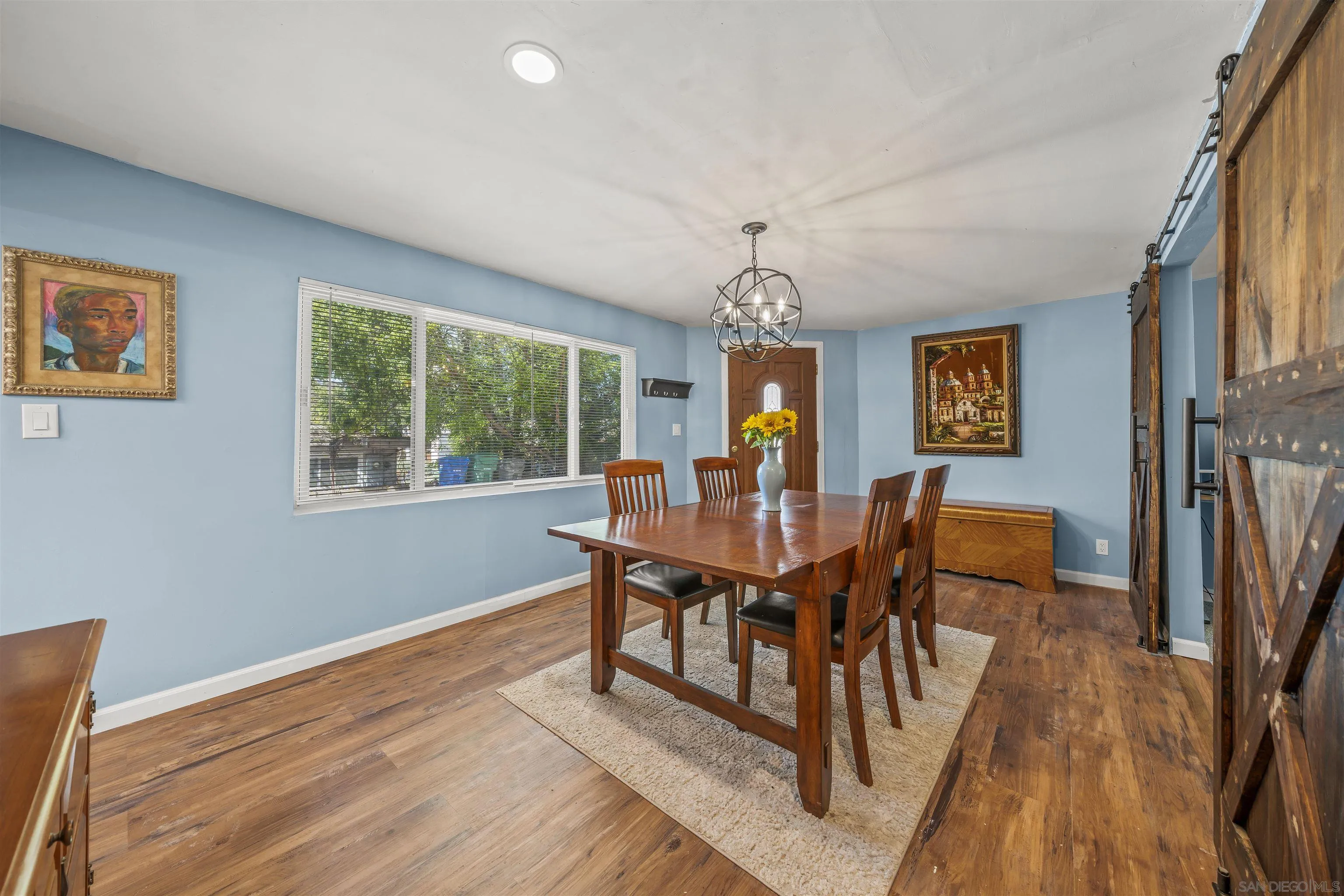 9240 Northcote Road Santee, CA 92071 - Photo 17 of 45 a view of a dining room with furniture a chandelier and wooden floor