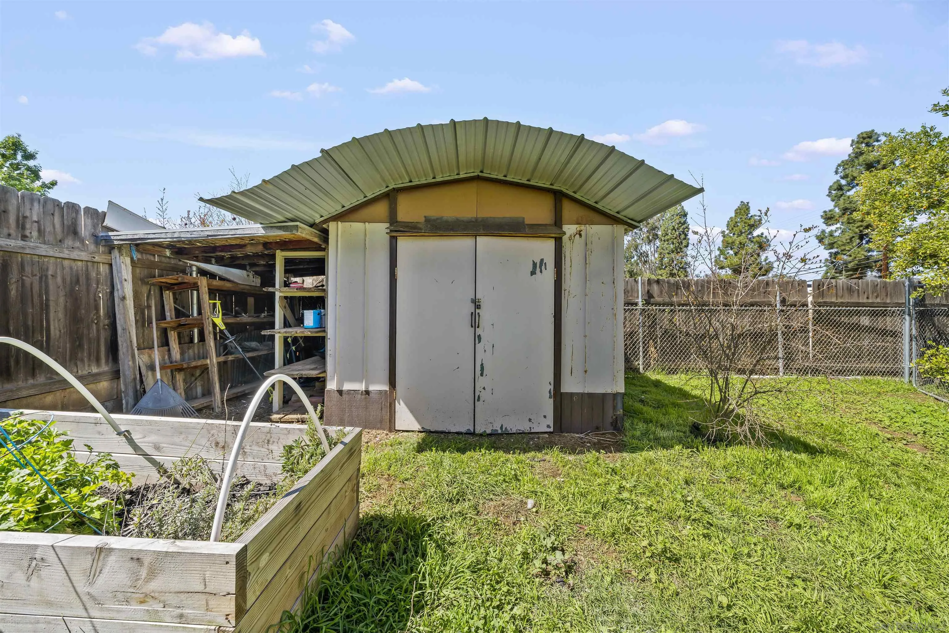 9240 Northcote Road Santee, CA 92071 - Photo 34 of 45 a view of a backyard with plants and wooden fence