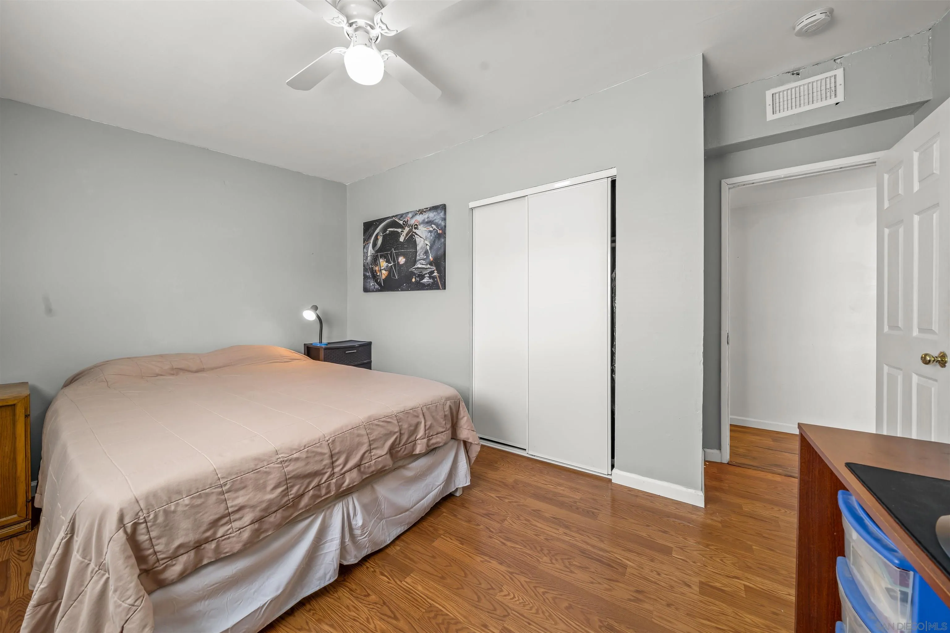 9240 Northcote Road Santee, CA 92071 - Photo 41 of 45 a bedroom with a bed and wooden floor