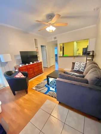 a bedroom with furniture and a large window