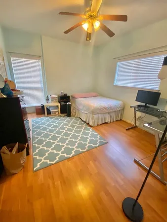 a bedroom with bed and a chandelier