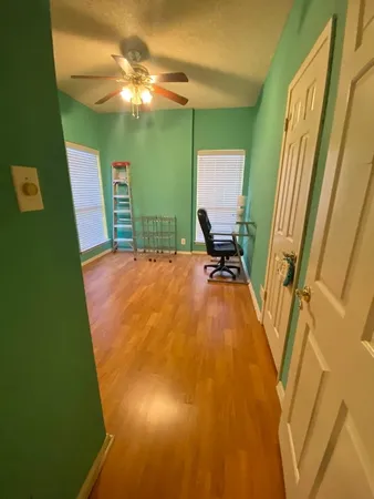 a view of a room with window and hardwood