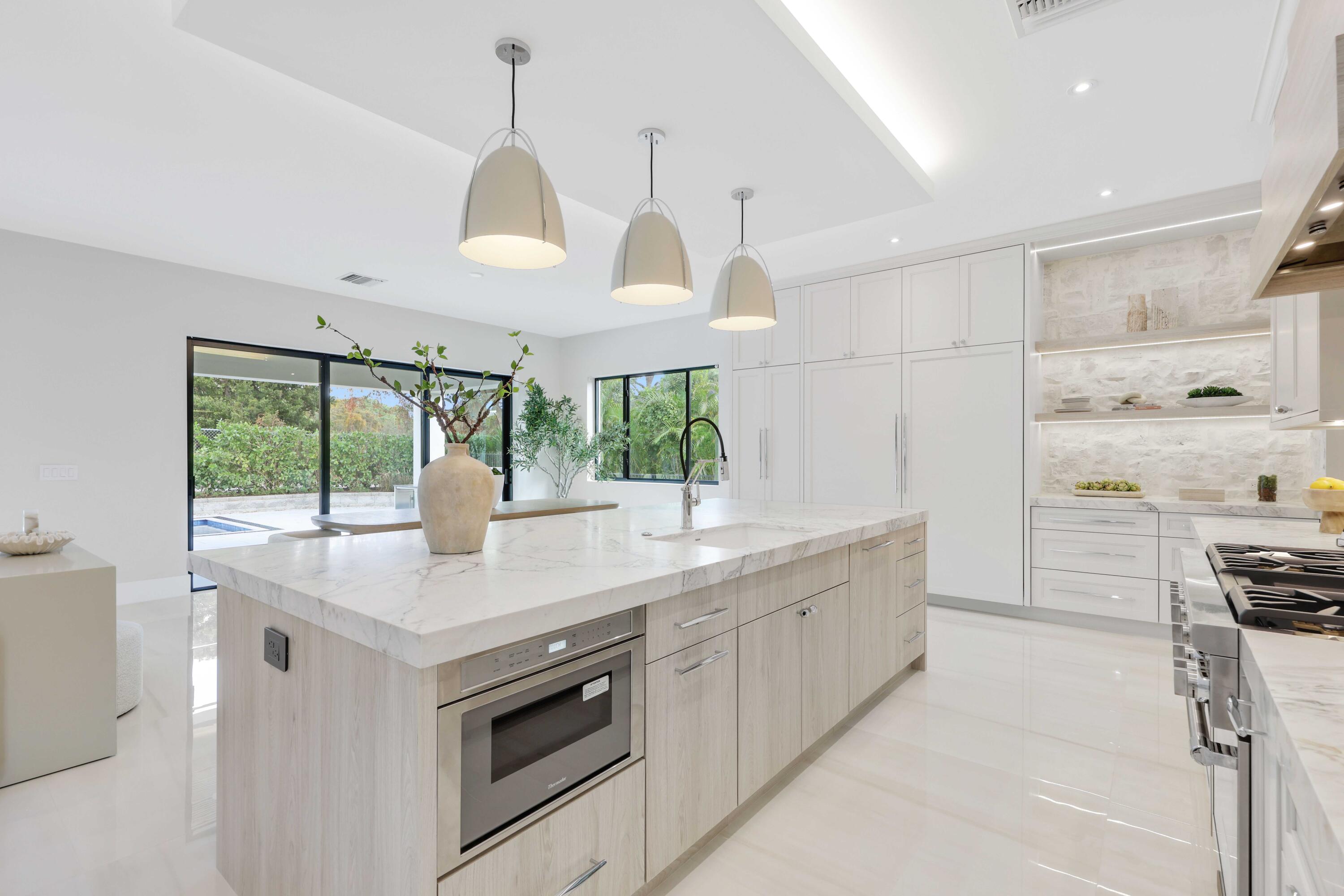 151 Eden Ridge Lane Boynton Beach, FL 33435 - Photo 19 of 74 a kitchen with stainless steel appliances granite countertop a stove a sink and a refrigerator with wooden floor