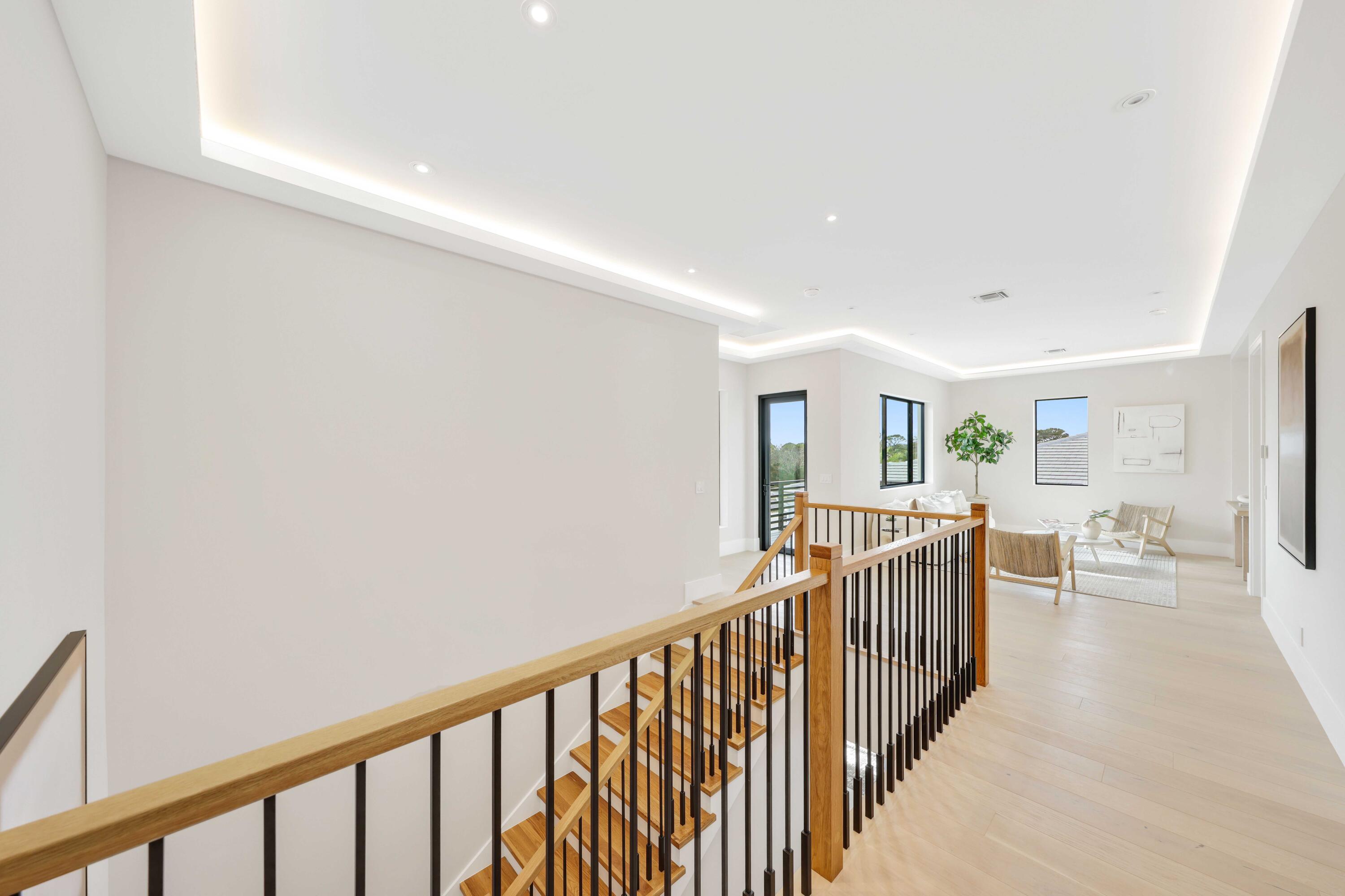 151 Eden Ridge Lane Boynton Beach, FL 33435 - Photo 34 of 74 a view of a hallway with wooden floor and windows