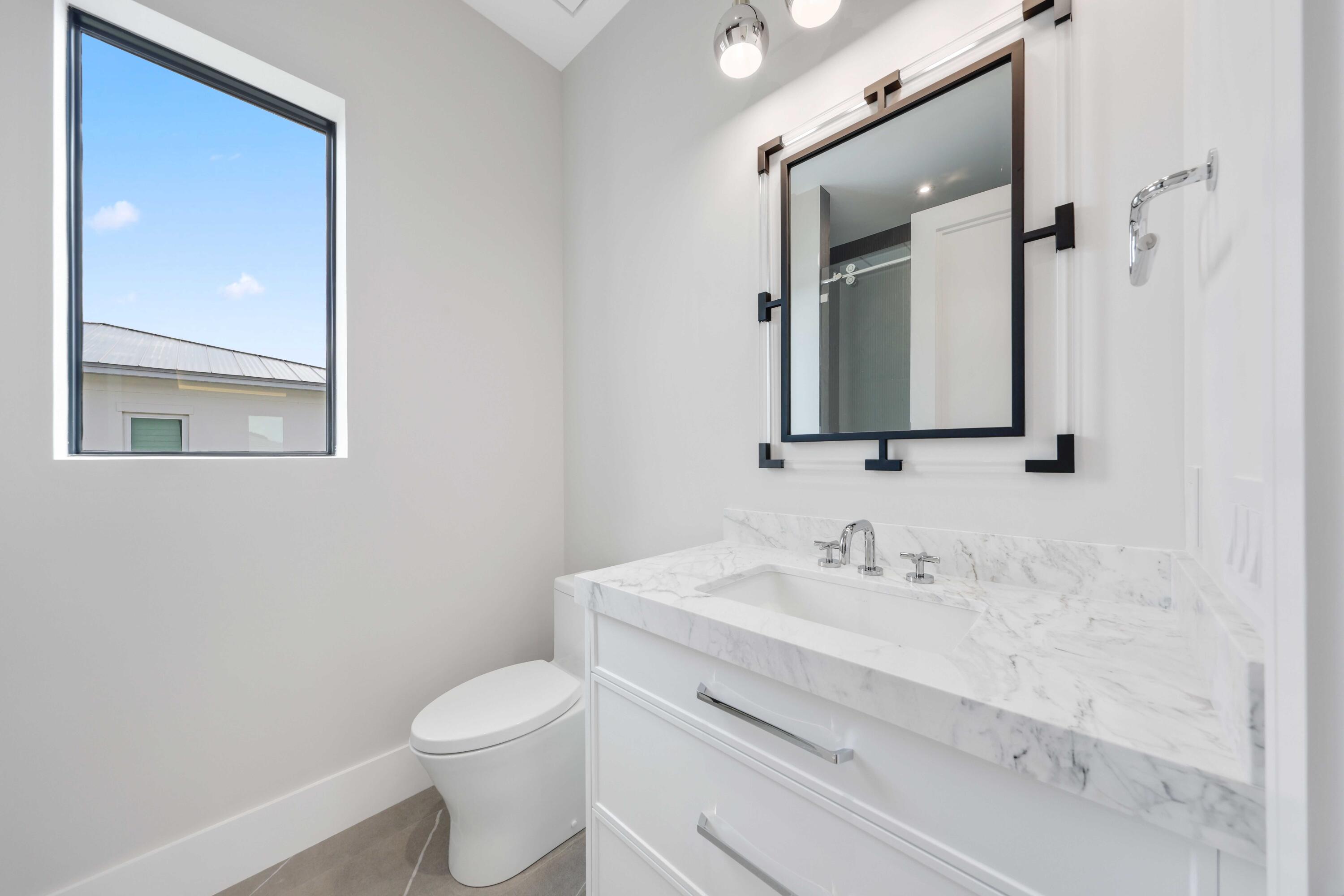151 Eden Ridge Lane Boynton Beach, FL 33435 - Photo 51 of 74 a bathroom with a sink vanity mirror and toilet