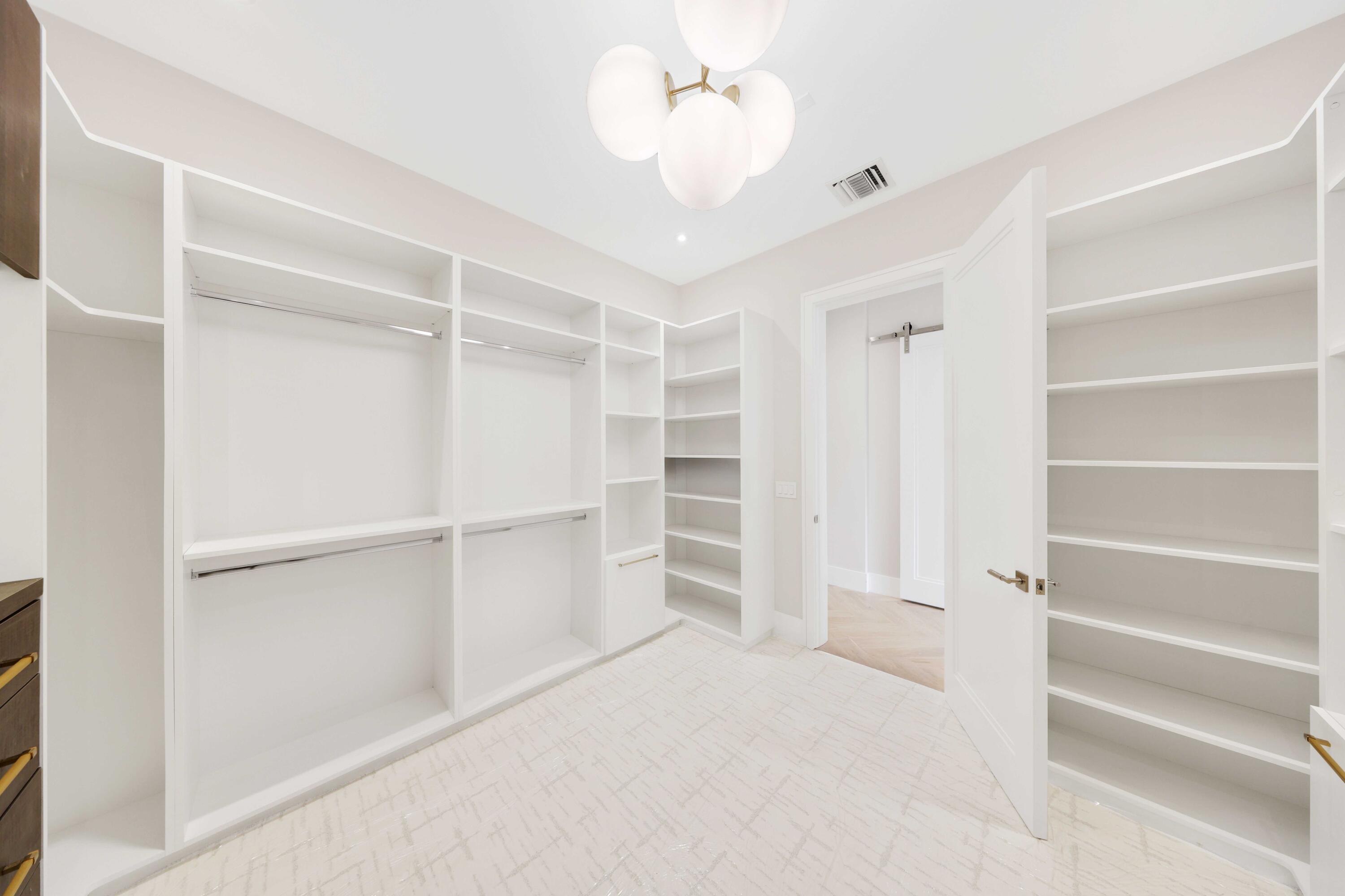 151 Eden Ridge Lane Boynton Beach, FL 33435 - Photo 59 of 74 a view of an empty walk in closet