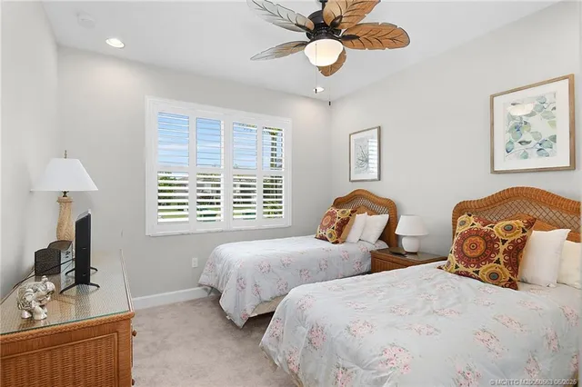 a bedroom with two beds and a window