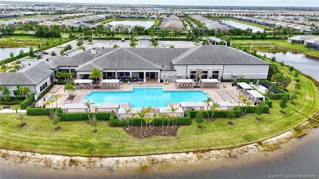an aerial view of residential houses with outdoor space and parking