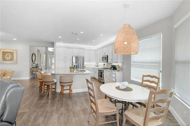 a view of a dining room with furniture and wooden floor