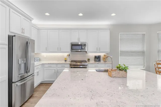 a kitchen with a refrigerator and a sink