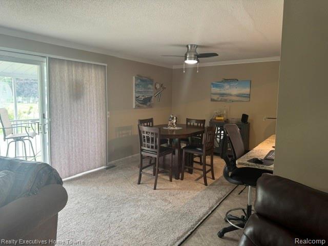 1467 Krafft Road, Unit 8 Port Huron, MI 48060 - Photo 7 of 28 Open-concept living area featuring light-toned carpeting, a ceiling fan with integrated lighting, and crown molding
