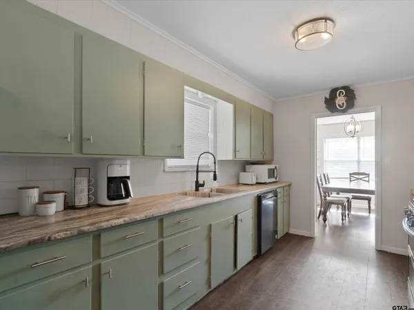 a kitchen with a stove and white cabinets