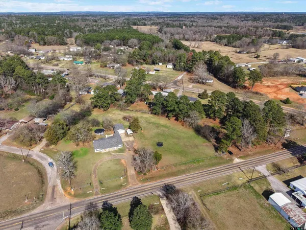 an aerial view of a house with a yard