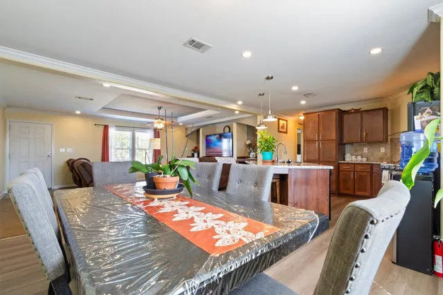 a living room with furniture kitchen and a table