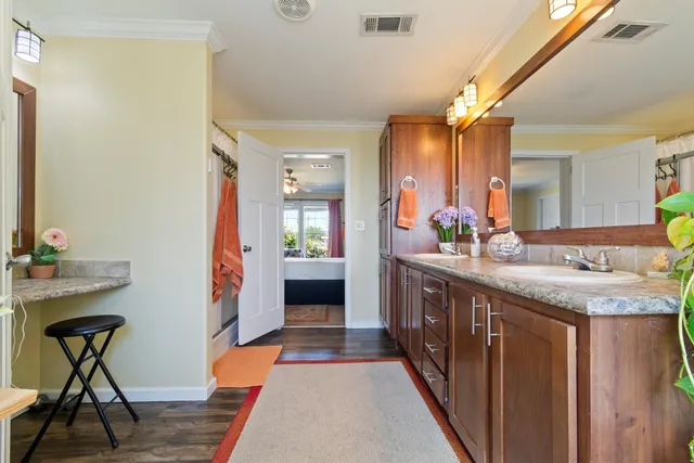a spacious bathroom with a granite countertop sink and a mirror