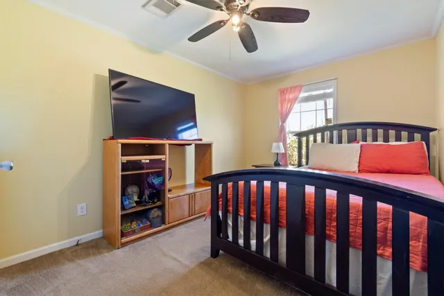 a bedroom with furniture and a flat screen tv