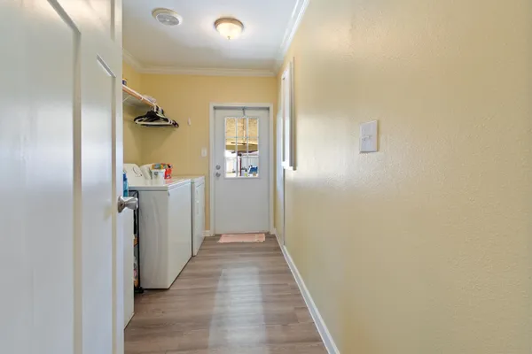 a view of a hallway with wooden floor