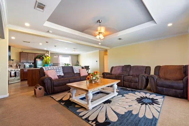 a living room with furniture a ceiling fan and a rug