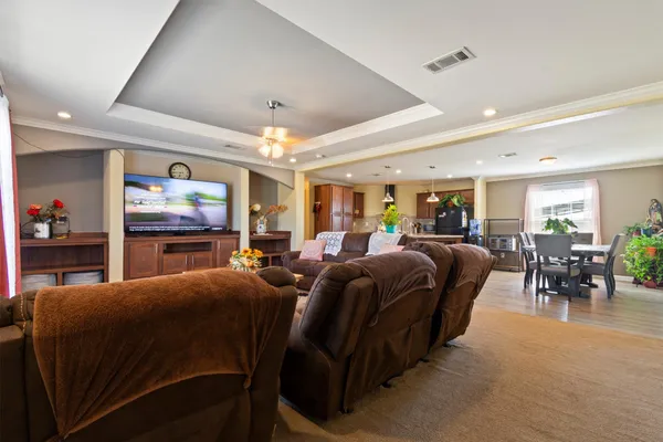 a living room with furniture a ceiling fan and a window