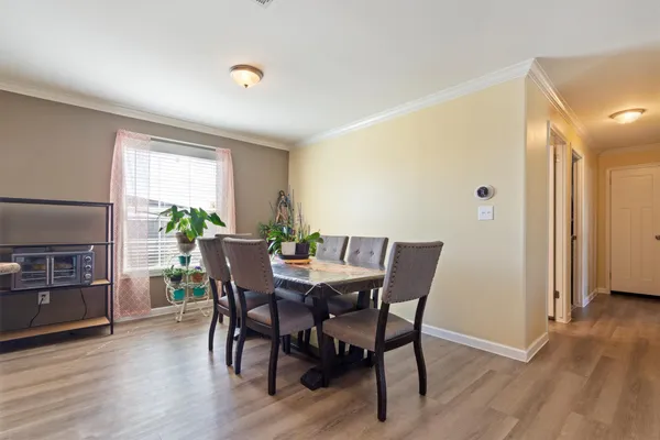 a view of a dining room with furniture window and wooden floor