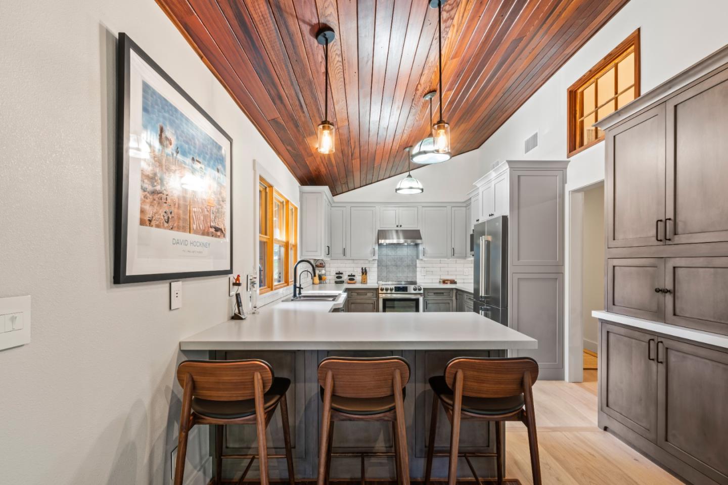 126 Filbert Road Woodside, CA 94062 - Photo 19 of 61 a dining hall with stainless steel appliances kitchen island granite countertop a table chairs and a refrigerator