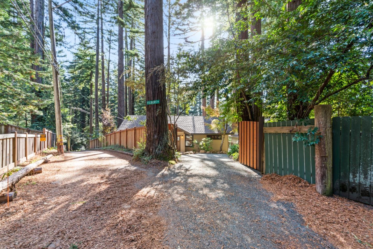 126 Filbert Road Woodside, CA 94062 - Photo 52 of 61 a backyard of a house with large trees and wooden fence