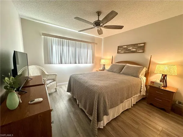 a bedroom with a bed dresser and a window