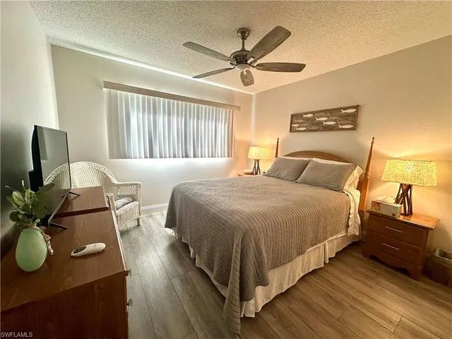 a bedroom with a bed dresser and a window