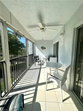 a view of a patio with dining table and chairs