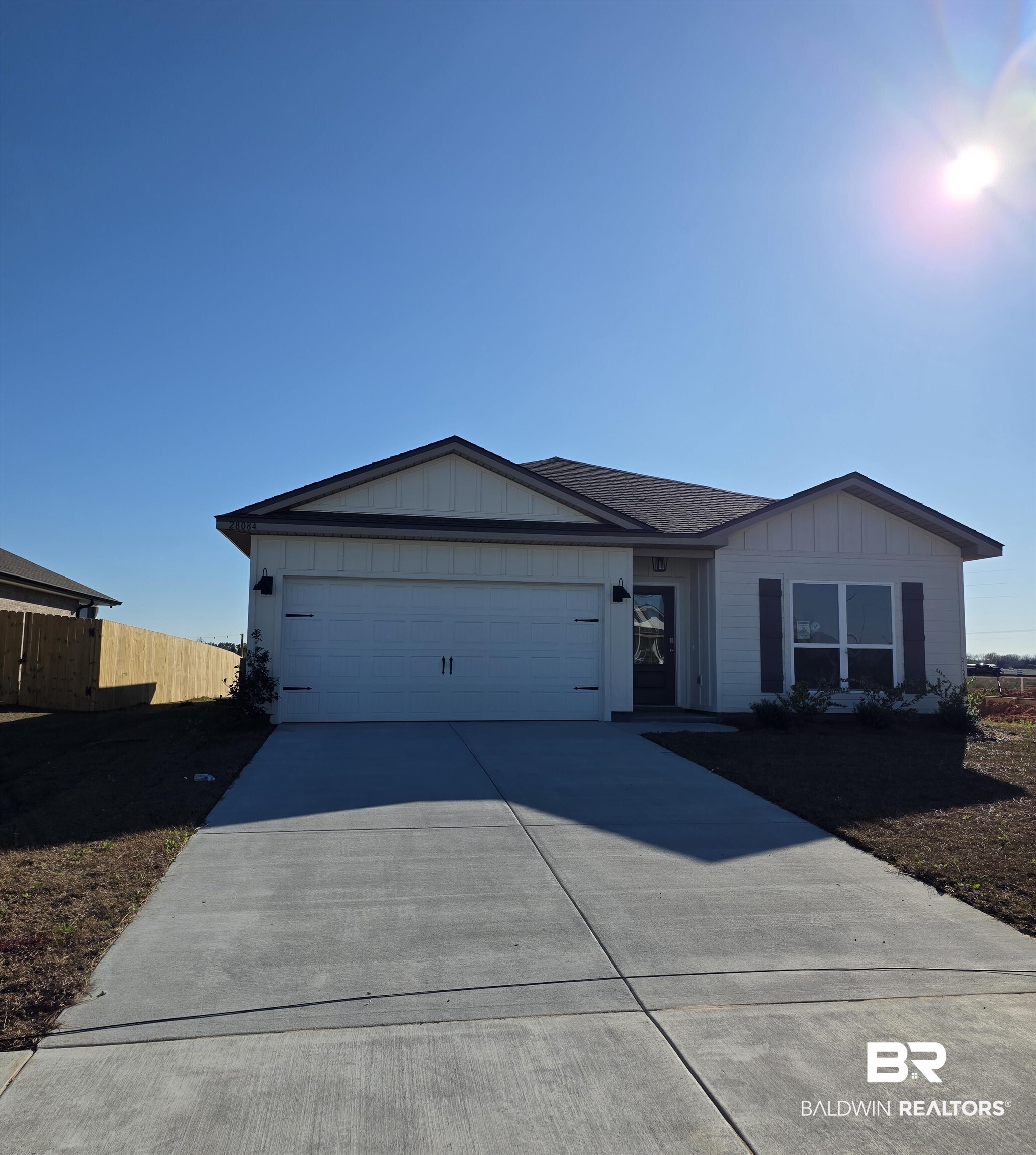 28084 Hallow Trail Elberta, AL 36530 - Photo 1 of 21 Single story home with board and batten siding, concrete driveway, and a garage