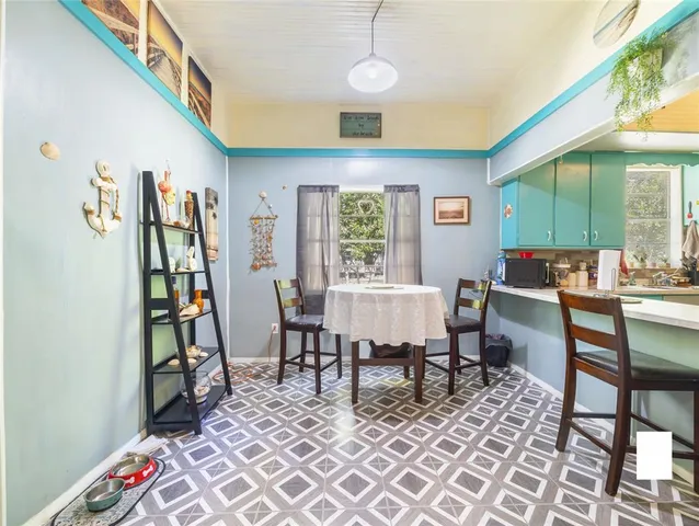 a view of an empty room and kitchen view
