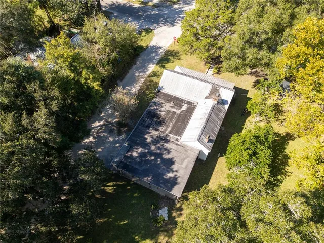 a view of a house with swimming pool and sitting area
