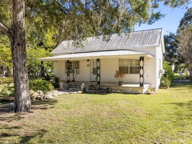 a view of a house with backyard porch and sitting area