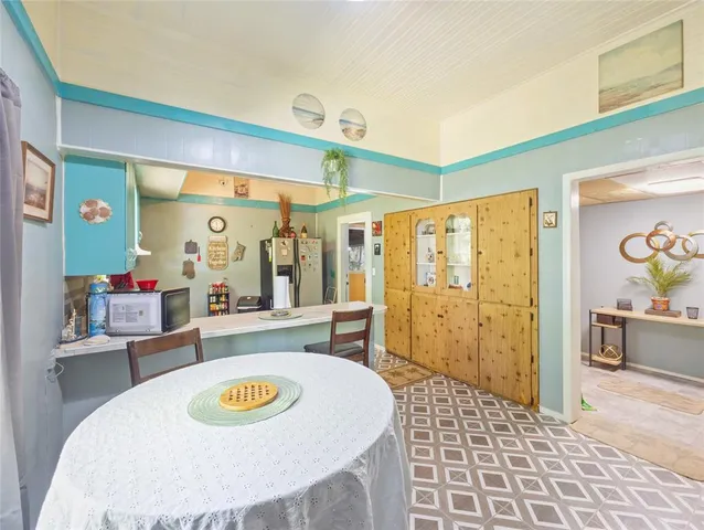 a kitchen with a refrigerator and a sink