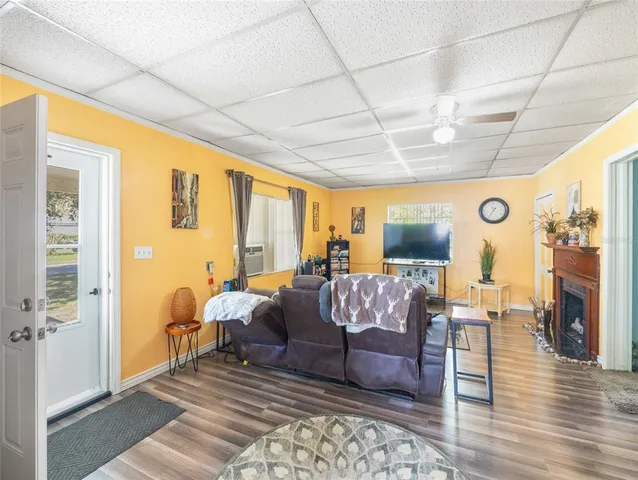 a living room with furniture fireplace and flat screen tv
