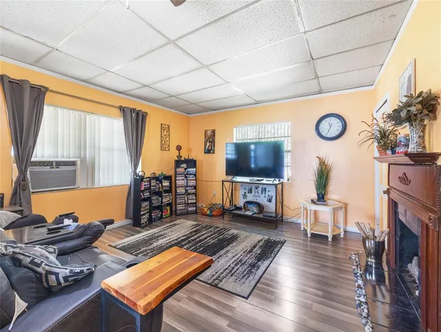 a view of a patio with table and chairs under an umbrella with large trees