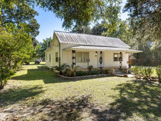 a front view of house with yard patio and green space