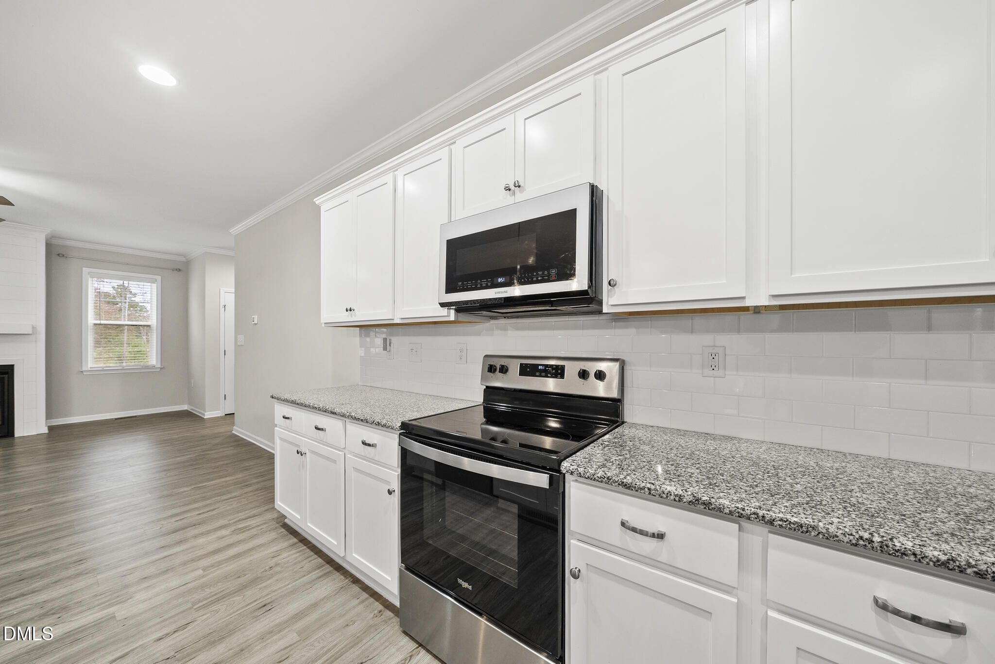 1177 Mudham Road Wendell, NC 27591 - Photo 5 of 30 a kitchen with granite countertop white cabinets and black appliances