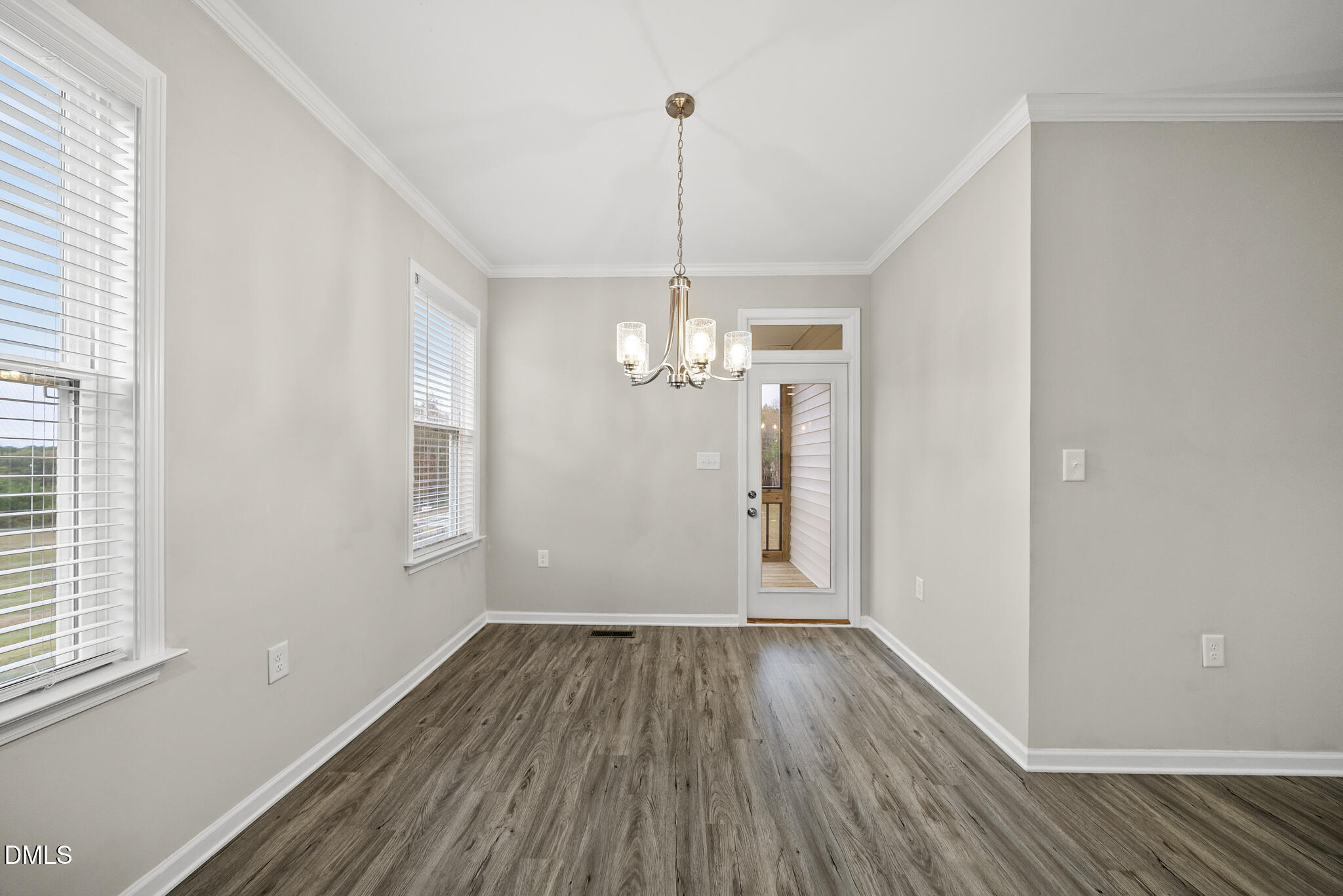 1177 Mudham Road Wendell, NC 27591 - Photo 9 of 30 a view of a room with wooden floor a ceiling fan and windows