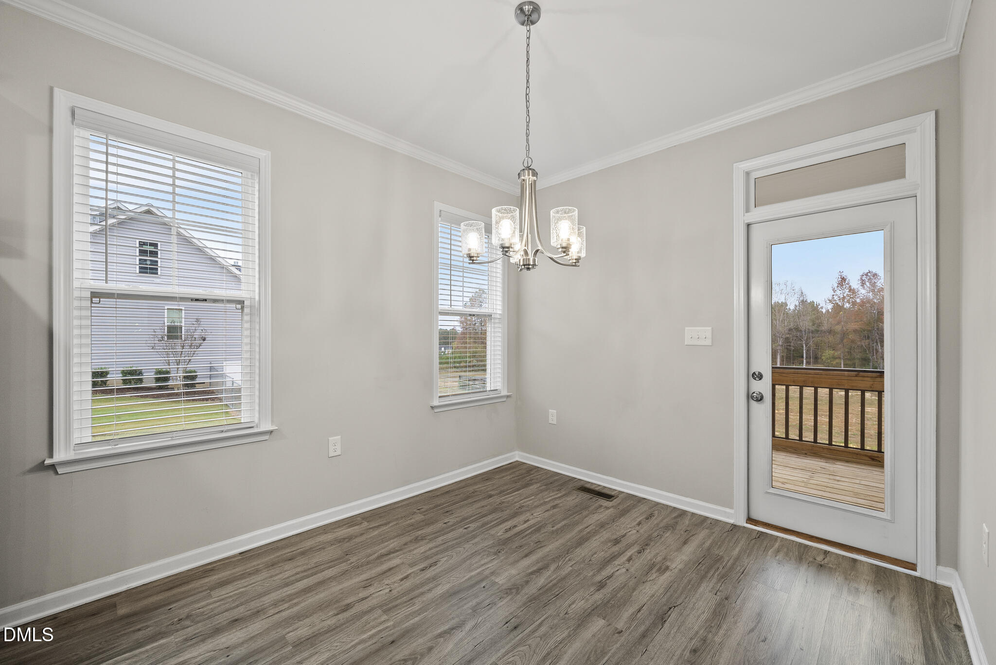 1177 Mudham Road Wendell, NC 27591 - Photo 10 of 30 a view of an empty room with wooden floor and a window
