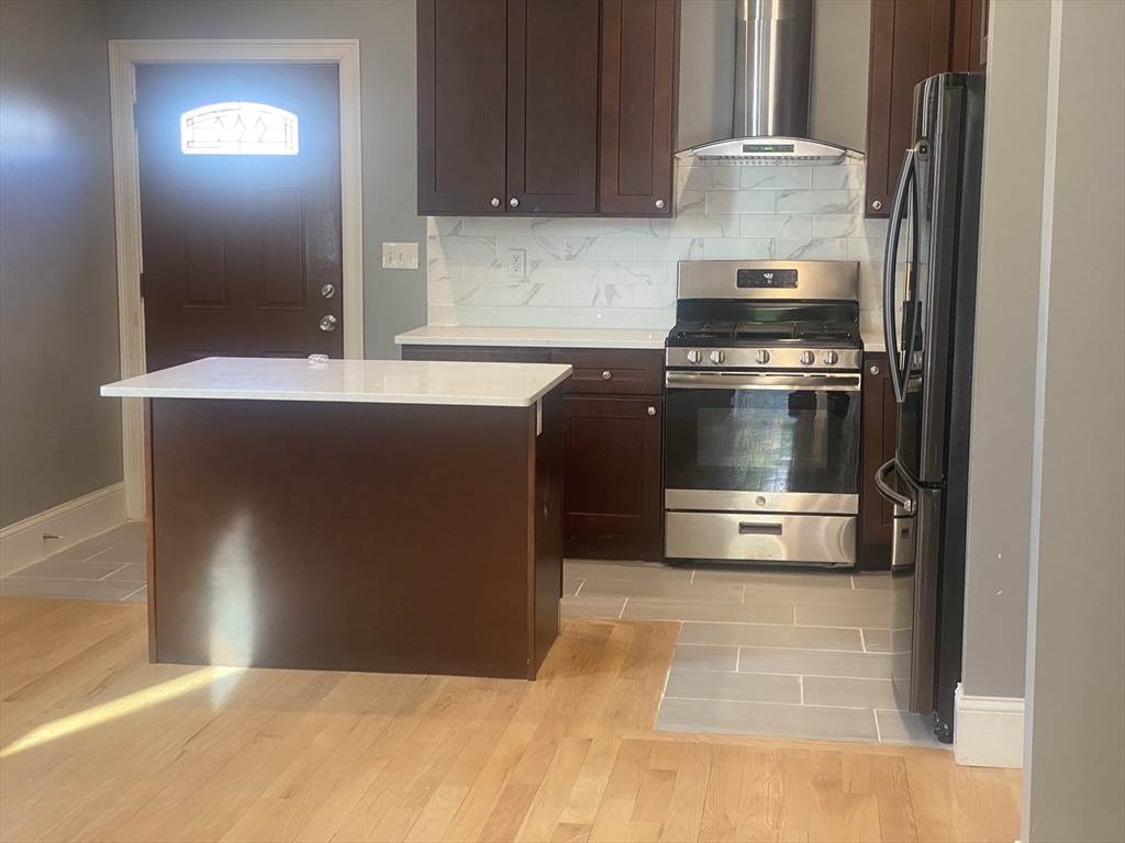 4 Hopestill Street, Unit 1 Boston, MA 02124 - Photo 4 of 5 a kitchen with a stove and a refrigerator