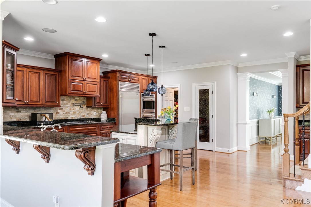 521 Raleigh Manor Road Henrico, VA 23229 - Photo 16 of 46 a kitchen with stainless steel appliances granite countertop a stove refrigerator and cabinets