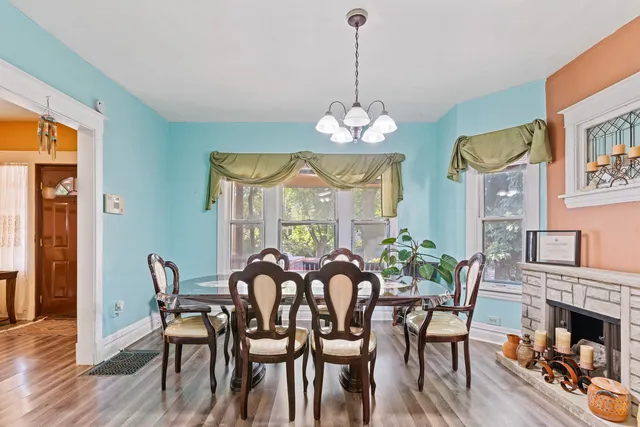 a view of a dining room with furniture wooden floor and chandelier