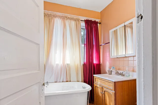 a bathroom with a sink a toilet and tub
