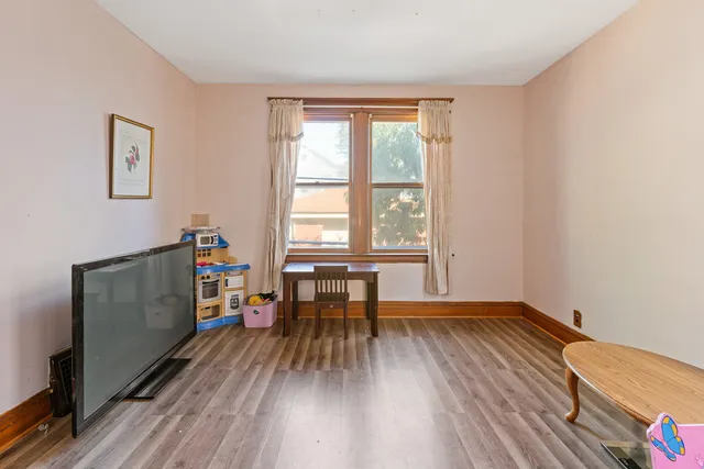 a view of room with window and wooden floor