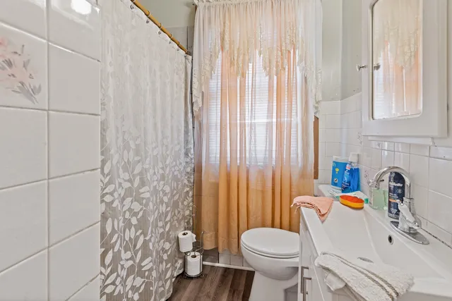 a white toilet sitting next to a bathroom sink