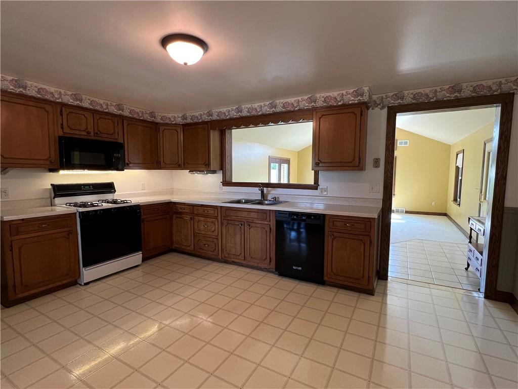 383 Bonniebrook Road Butler, PA 16002 - Photo 12 of 25 a kitchen with stainless steel appliances granite countertop a sink counter space cabinets and a large window